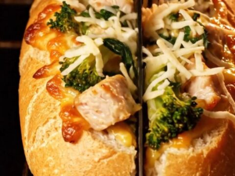 A golden-brown stuffed baguette filled with creamy chicken Alfredo and broccoli rabe.
