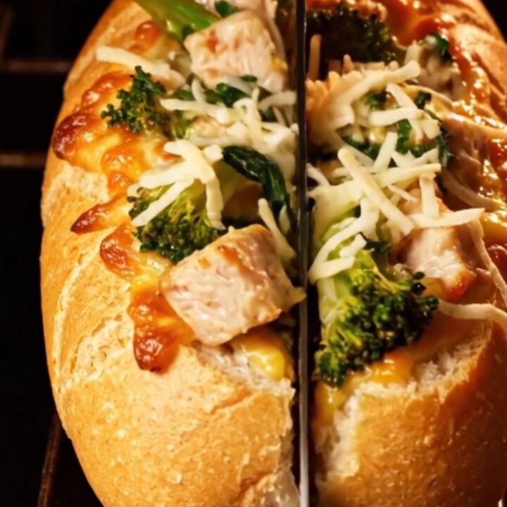 A golden-brown stuffed baguette filled with creamy chicken Alfredo and broccoli rabe.