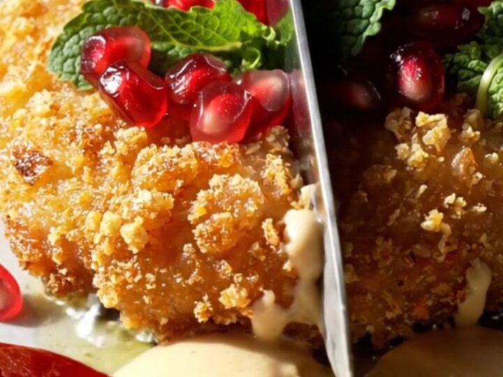 A crispy golden-brown za'atar chicken cutlet drizzled with white garlic tahini and topped with red pomegranate seeds.