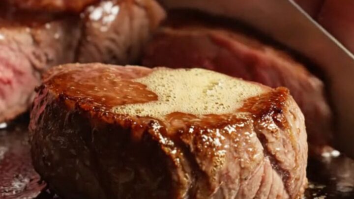 A close-up of perfectly seared venison medallions glistening with a truffle honey glaze.