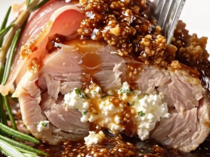 A perfectly seared prosciutto-wrapped chicken breast drizzled with glossy fig balsamic sauce.
