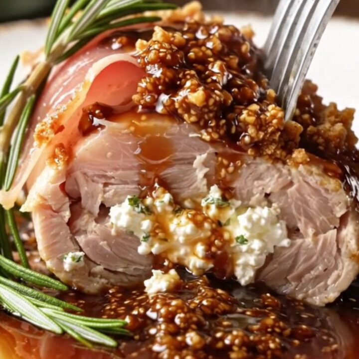 A perfectly seared prosciutto-wrapped chicken breast drizzled with glossy fig balsamic sauce.