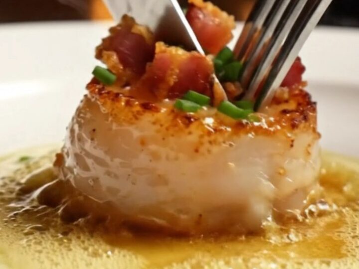 Golden-crusted jumbo sea scallops seared to perfection in a stainless steel skillet with crispy pancetta.