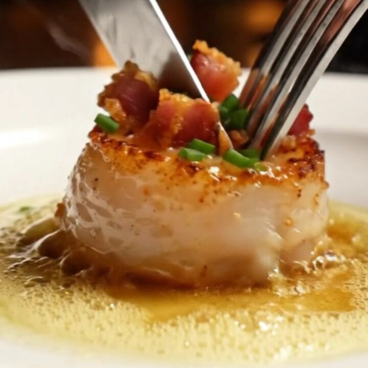 Golden-crusted jumbo sea scallops seared to perfection in a stainless steel skillet with crispy pancetta.