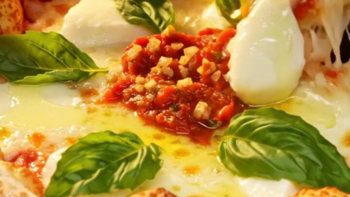 A crispy, square-cut Sicilian Grandma-style pizza with a golden, fried crust, melted mozzarella, and fresh basil leaves.