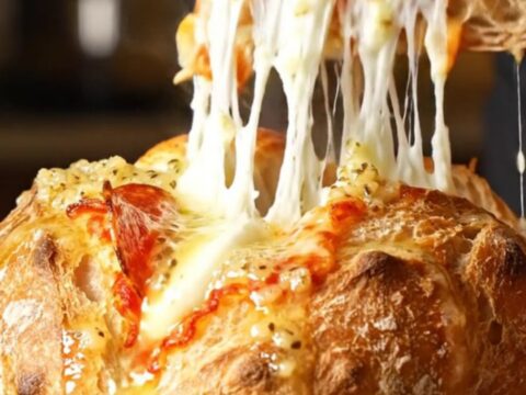 A crispy, golden-brown hasselback sourdough loaf stuffed with melted mozzarella and pepperoni.