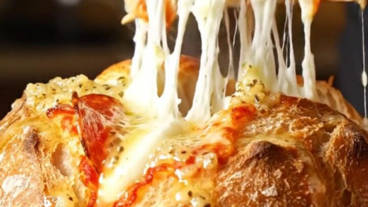 A crispy, golden-brown hasselback sourdough loaf stuffed with melted mozzarella and pepperoni.