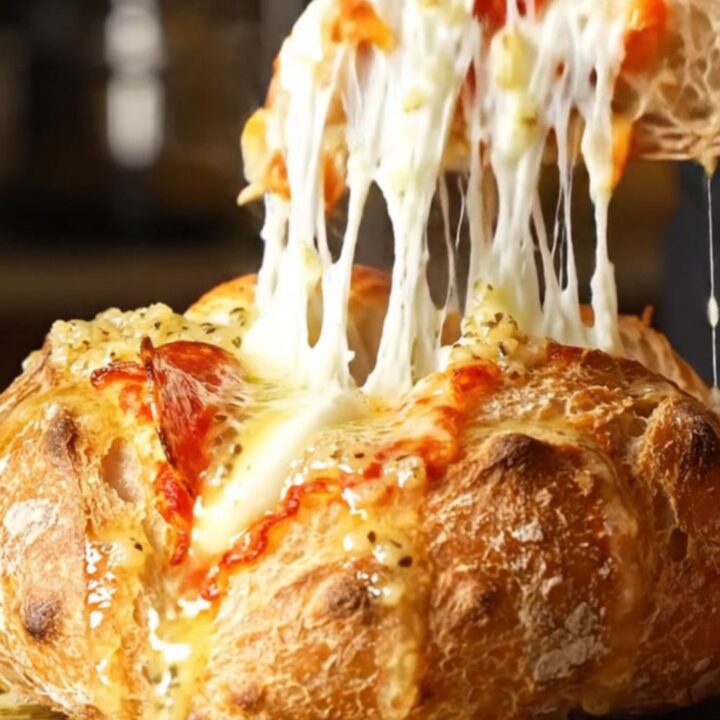 A crispy, golden-brown hasselback sourdough loaf stuffed with melted mozzarella and pepperoni.