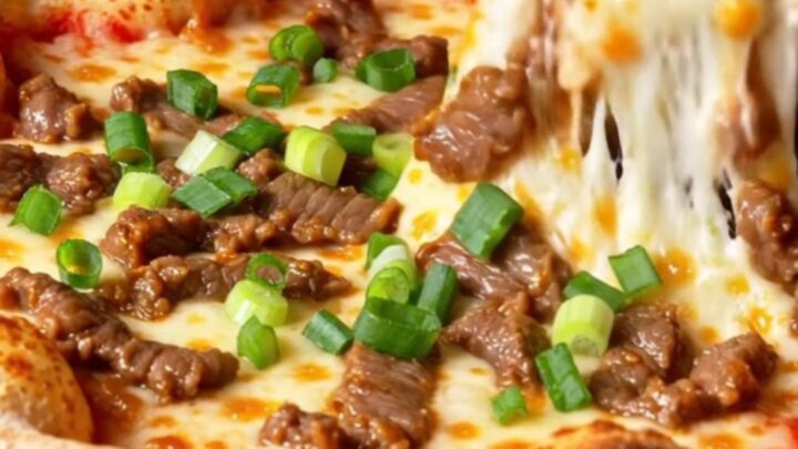 A slice of Korean corn-cheese stuffed crust pizza being lifted, showing stretchy mozzarella and sweet corn.