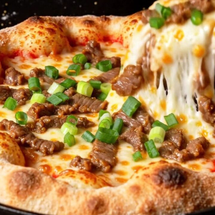 A slice of Korean corn-cheese stuffed crust pizza being lifted, showing stretchy mozzarella and sweet corn.