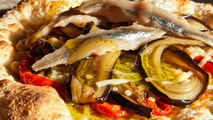 A rustic, crispy Catalan Coca flatbread topped with roasted red peppers, charred eggplant, and anchovies.