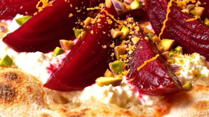 A crispy za'atar flatbread topped with swirls of whipped goat cheese and roasted beet wedges