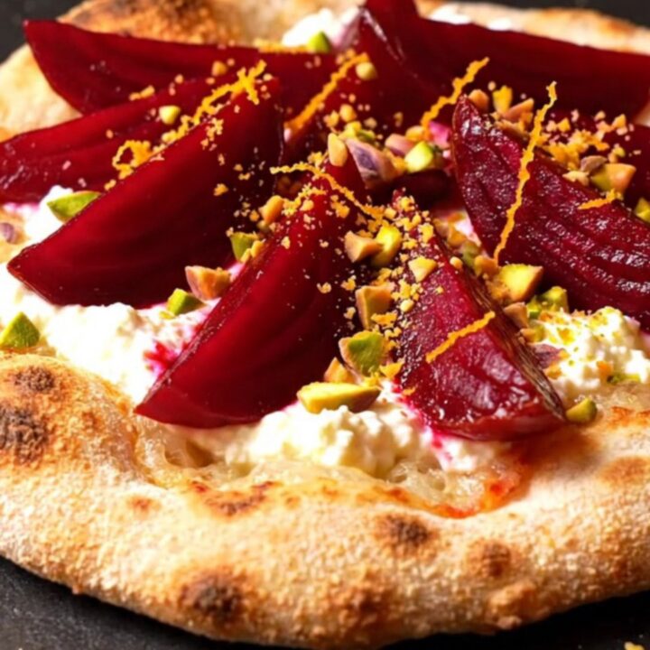 A crispy za'atar flatbread topped with swirls of whipped goat cheese and roasted beet wedges