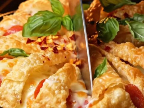 A close-up of a golden, accordion-pleated phyllo pizza tart with bubbling mozzarella and pepperoni.