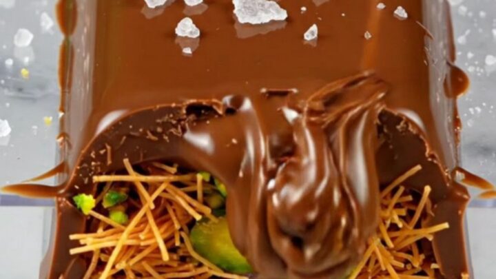 A close-up of a broken Dubai pistachio chocolate bar showing the bright green filling.