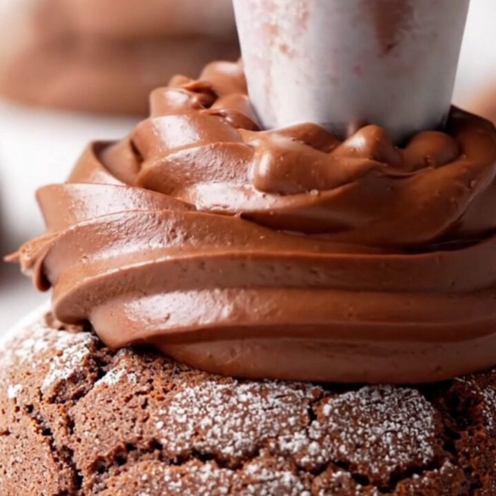A close-up view of a chilled double fudge cookie, cut in half to show the dense chocolate base and the thick