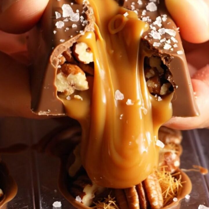 A close-up of a broken Salted Caramel Pecan Dubai Chocolate Bar showing the gooey caramel and crispy kataifi layers.