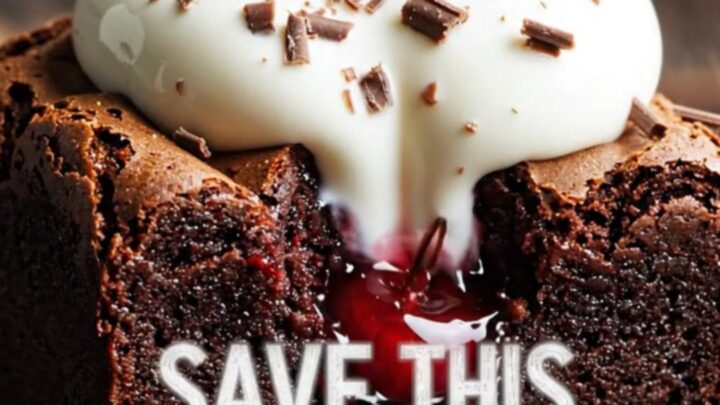 A close-up of a fork breaking into a fudgy dark chocolate brownie with visible cherry pockets and mascarpone cream.