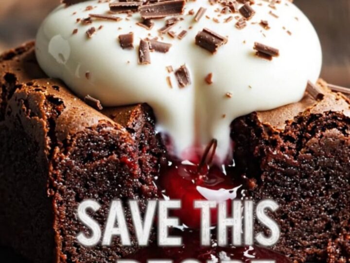 A close-up of a fork breaking into a fudgy dark chocolate brownie with visible cherry pockets and mascarpone cream.