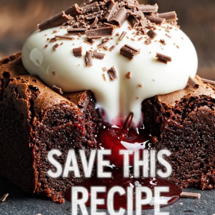A close-up of a fork breaking into a fudgy dark chocolate brownie with visible cherry pockets and mascarpone cream.