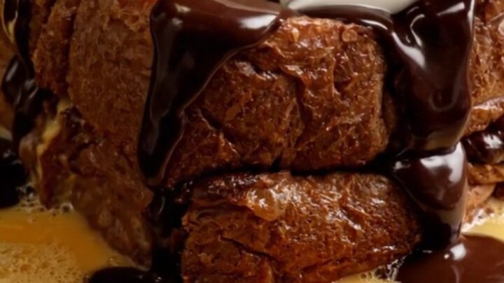 Extreme close-up of caramelized chocolate babka French toast with mascarpone and chocolate fudge.