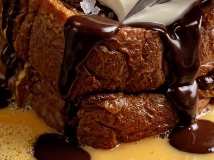 Extreme close-up of caramelized chocolate babka French toast with mascarpone and chocolate fudge.