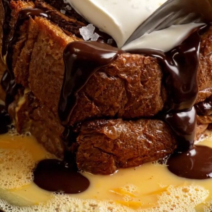 Extreme close-up of caramelized chocolate babka French toast with mascarpone and chocolate fudge.