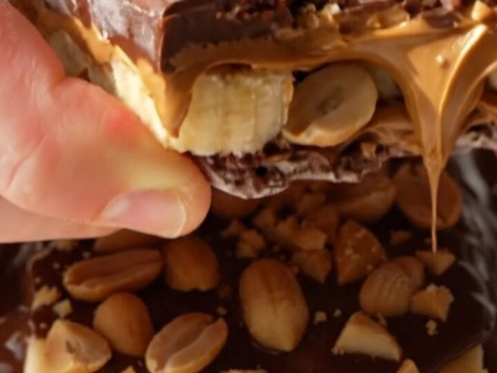 A close-up of frozen banana bark shards showing layers of banana, peanut butter, and dark chocolate.