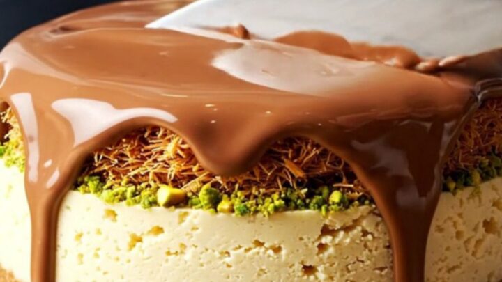 A close-up shot of a Dubai pistachio kunafa cheesecake bar with a visible crunchy pistachio layer.