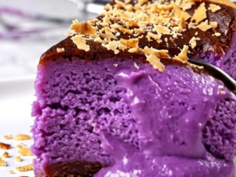 A vibrant purple Ube Basque cheesecake with a perfectly charred, dark bronze crust sitting on a modern kitchen counter.