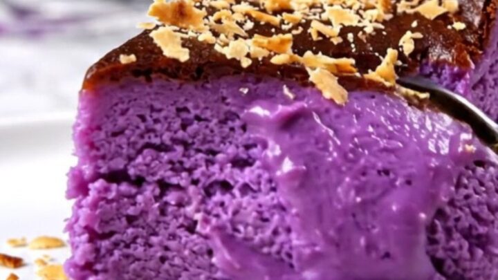A vibrant purple Ube Basque cheesecake with a perfectly charred, dark bronze crust sitting on a modern kitchen counter.