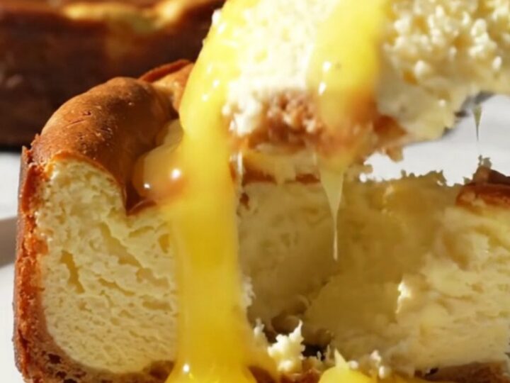 A close-up shot of a slice of Meyer lemon Basque cheesecake with a molten center and a burnt top.