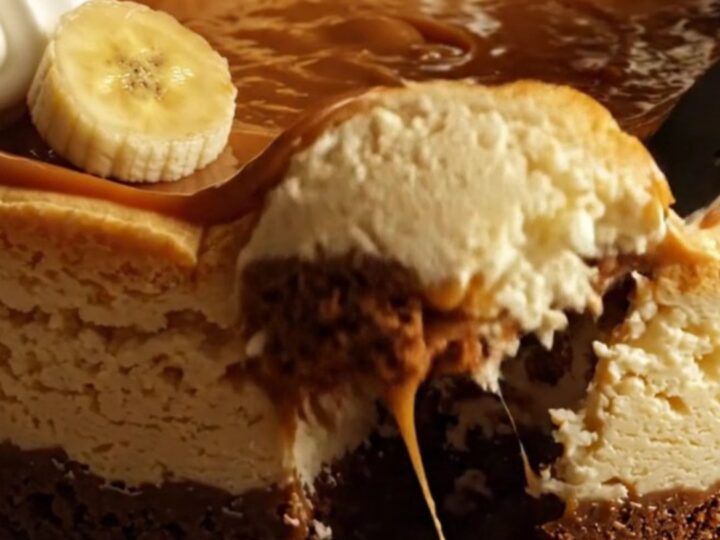 A slice of decadent banoffee cheesecake with a biscuit base and caramel topping.