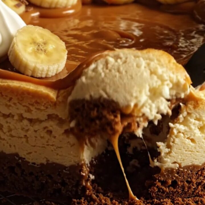A slice of decadent banoffee cheesecake with a biscuit base and caramel topping.