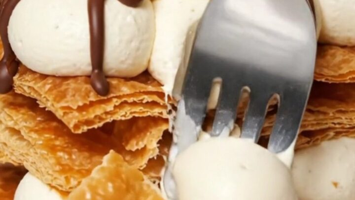 A three-tier Napoleon Mille-Feuille showing layers of crisp puff pastry and vanilla bean cream.