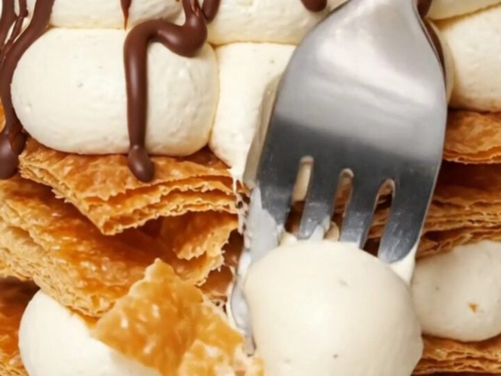 A three-tier Napoleon Mille-Feuille showing layers of crisp puff pastry and vanilla bean cream.
