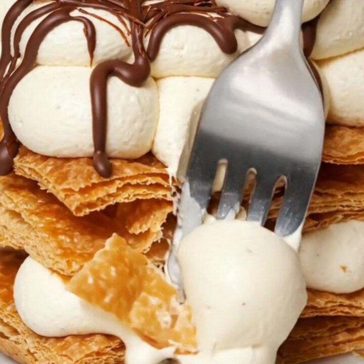 A three-tier Napoleon Mille-Feuille showing layers of crisp puff pastry and vanilla bean cream.