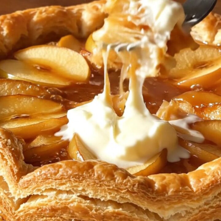 A golden, caramelized Apple Tarte Tatin served on a rustic platter.