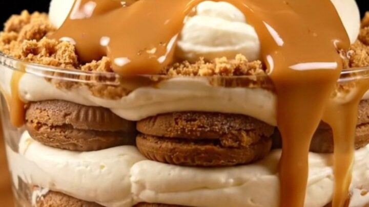 A close-up of a creamy Lotus Biscoff tiramisu in a square dish with a spoonful being taken out.