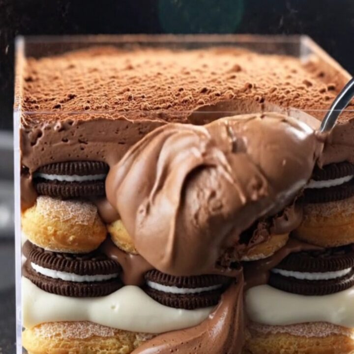 A towering, decadent Oreo Fudge Mocha Tiramisu Box with visible layers of chocolate mousse and espresso-soaked cookies.