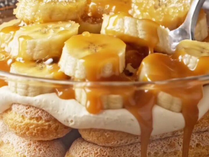 A slice of salted caramel banana tiramisu showing distinct layers of cream and ladyfingers.