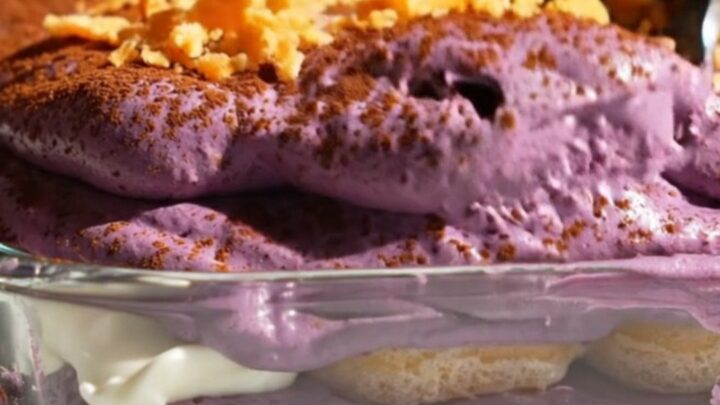 A close-up shot of a square portion of vibrant purple ube halaya coconut tiramisu on a plate.