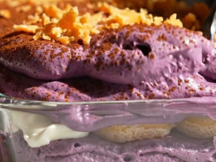 A close-up shot of a square portion of vibrant purple ube halaya coconut tiramisu on a plate.