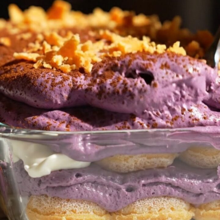 A close-up shot of a square portion of vibrant purple ube halaya coconut tiramisu on a plate.