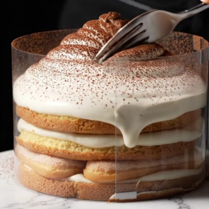 A close-up view of the tsunami tiramisu with a cascading layer of mascarpone cream over ladyfingers.