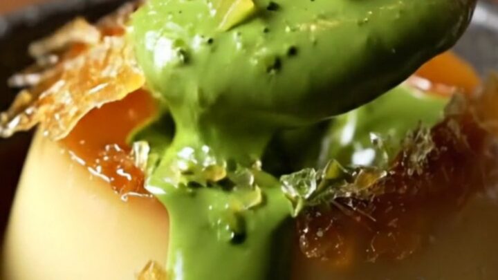 A close-up of a jade-green matcha crème brûlée with a shattered amber sugar crust.