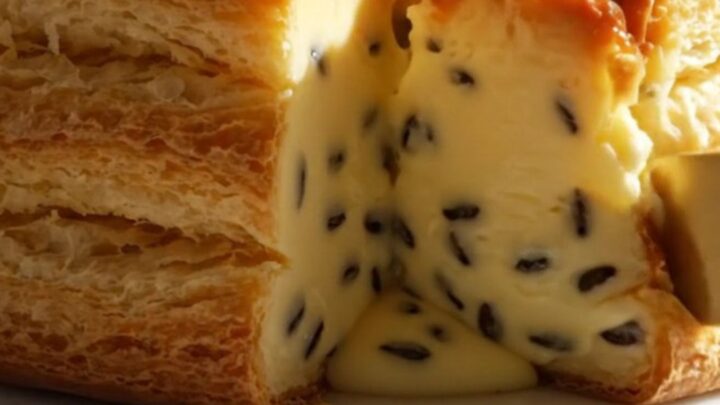 A tall, beautiful slice of Parisian flan pâtissier with a blistered top and smooth custard.