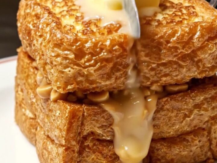 A golden-brown crispy Hong Kong style peanut butter French toast topped with a melting pat of butter and condensed milk.