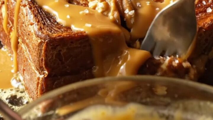 A golden-brown slice of walnut banana bread French toast topped with glossy tahini caramel and sea salt.