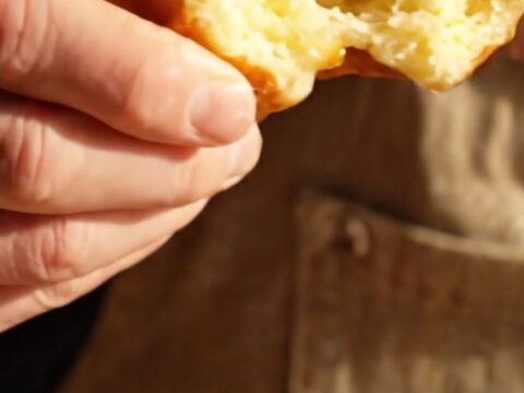 A close-up of a warm Belgian Liège waffle showing the texture of the caramelized sugar.